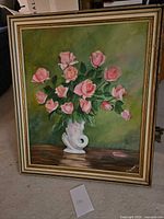 Full view of signed oil painting of pink roses in frame