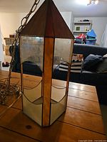 Full view of the hanging pendant light showing hexagonal shape and chain