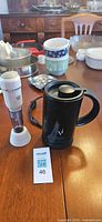 Verismo electric milk frother, handheld frother, lot tag visible