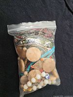 Sealed plastic bag showing full assortment of jewelry pieces