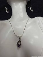 Necklace and earrings displayed on bust for scale and design view
