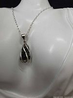 Pendant on mannequin showing scale and design