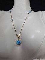 Necklace displayed on bust showing pendant and bead accents