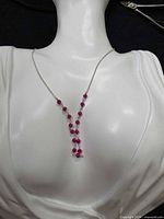 Necklace displayed on bust showing Y-drop and bead arrangement