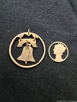 Front view of both pendants on dark fabric