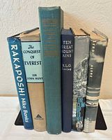 Spine view of all six hardcover books showing titles and general condition
