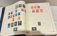 Open album showing Austria page with mounted stamps