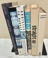 Spine view of all six hardcover books showing titles and authors