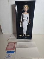 Full view of doll in original box with paperwork