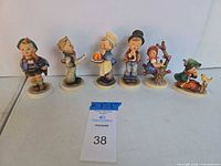 Front view of all six Hummel figurines