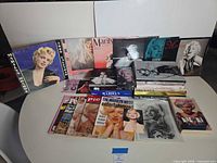 Full lot overview showing books, magazines, calendars, VHS and pins