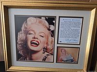 Front view of first framed Marilyn Monroe laughing portrait print showing frame, matting and text panel