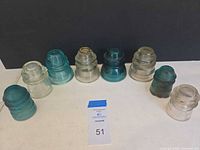 Front view of all eight Hemingray glass insulators lined up