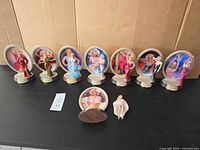 All eight figurines aligned on table showing overall set including detached piece