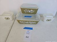 Full set of four covered dishes arranged