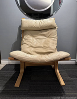Front view of chair showing leather cushions, bentwood frame