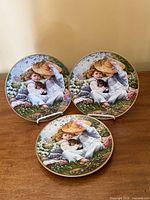 Front view of three identical decorative plates on stands