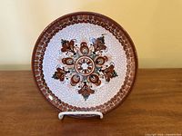 Front view showing floral design and crackle glaze