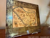 Angled front view showing map and gold frame