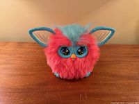 Front view eyes open showing coral fur, teal mane, teal facial features