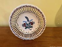 Front view of plate showing floral design and pierced rim