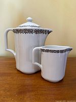 Coffee/tea pot with lid and creamer in white porcelain with gold trim