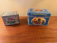 Front view of both tins