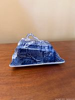 side view of blue and white transferware cheese dome lid