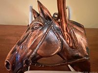 Front profile showing detailed horse head base