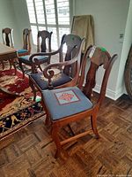 six wood dining chairs, two with arms, four without