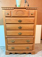 Front view of Athens Furniture five-drawer oak dresser
