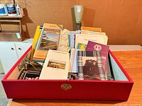 box filled with assorted maps, brochures, postcards