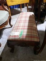 Side view showing carved wooden frame and plaid top