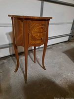 Front view showing two drawers, cabriole legs, pulls