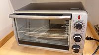 Front view of Black+Decker toaster oven showing overall condition, controls and glass door