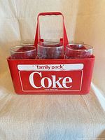 Front view of red Coca-Cola carrier loaded with six glasses