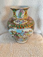 Front view of hand-painted Chinese porcelain vase showing bird and flower panel