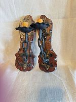 Front view of both wood and metal candle sconces