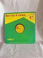 Front view of Record Corner Disco 45 sleeve with record visible through center cut-out