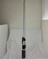 Full view of telescoped lightsaber blade and hilt