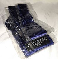 Necktie folded in original plastic sleeve with Wolfmark label visible