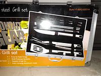 Retail box front showing VIP Grill Master stainless steel grill set and contents illustration
