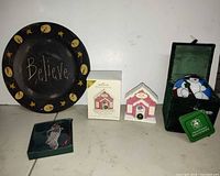 Group shot showing all items: plate, boxed Hallmark ornament, loose chapel ornament, angel ornament in green case, snowman ornament in velvet box