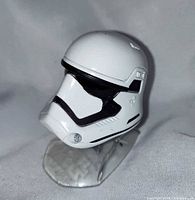 Front-left view of die-cast Stormtrooper helmet on stand