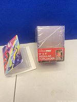 Front view: sealed Ultra Pro 3" x 4" toploader pack next to open Pokémon mini binder