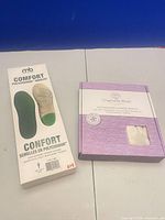 Front view of boxed insoles and heat pack