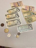 Group view of all banknotes, coins and medals on tabletop
