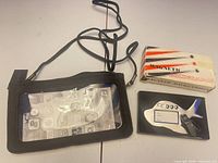 All three items: phone pouch, boxed magnetic backgammon, metal luggage tag