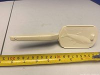 Scaler side with embossed cover and tape measure showing length