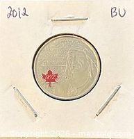 Obverse of coin in flip showing Tecumseh design and red maple leaf